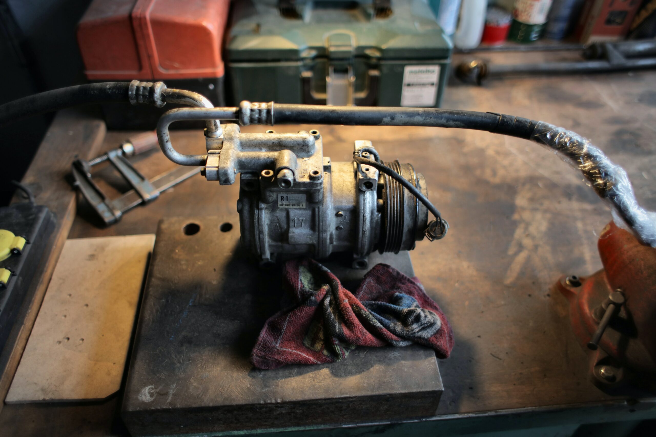Car air conditioner pump from modern vehicle on the table in a workshop
