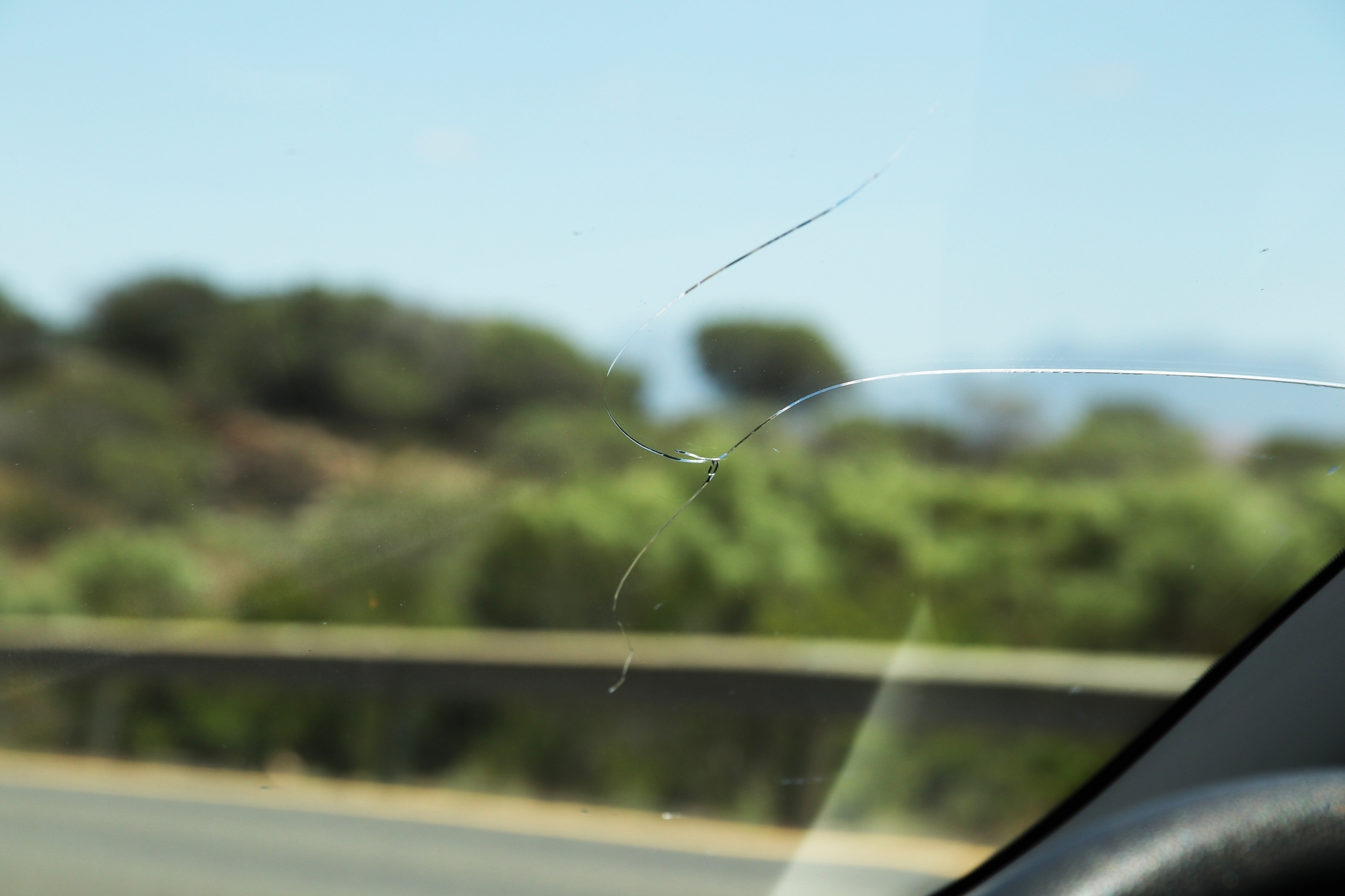 Close up photo of heavily damaged windshield