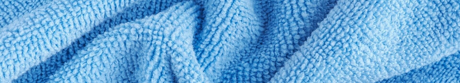 Very close up photo of light blue microfiber towel structure