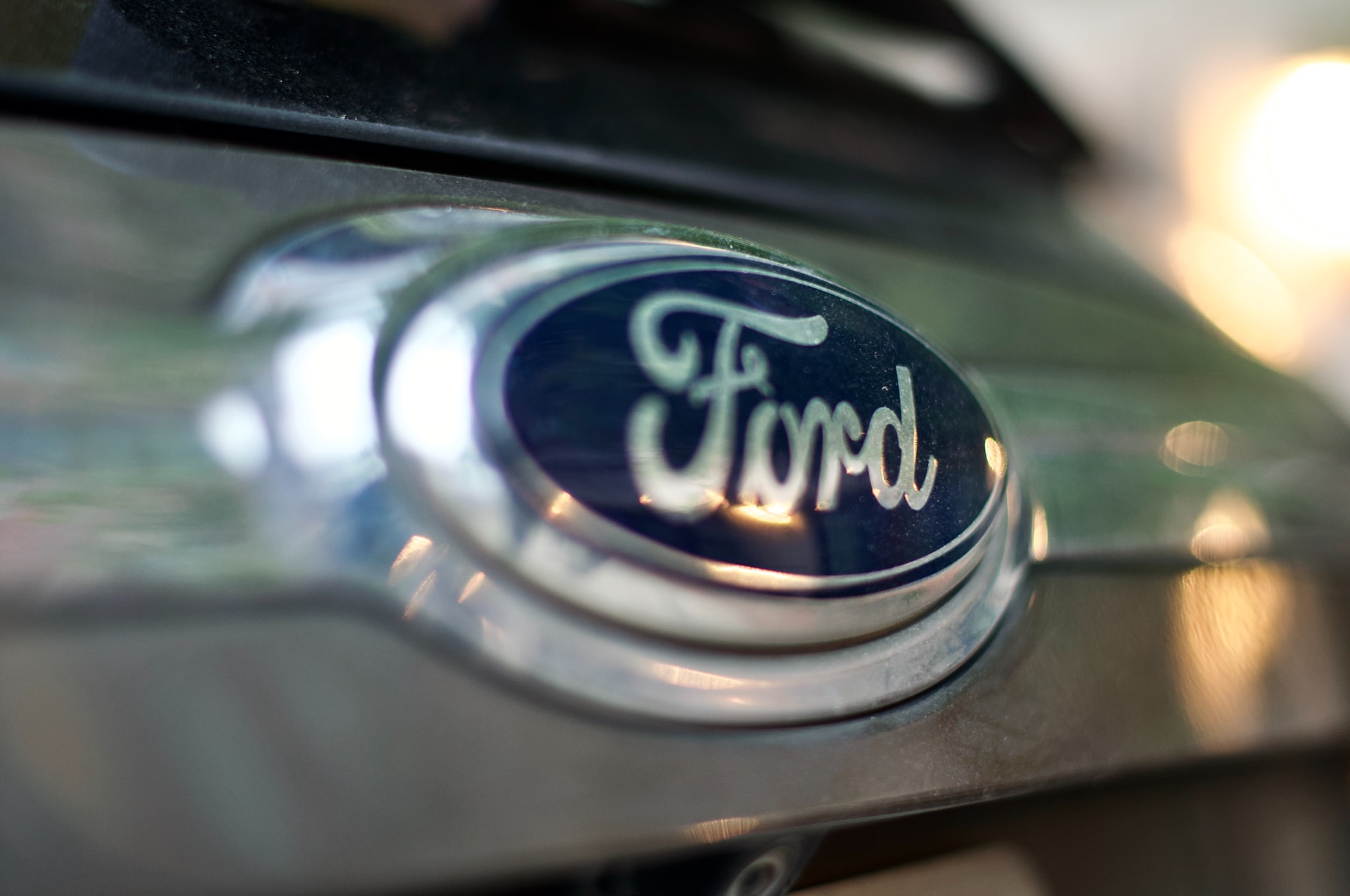 Ford badge on a front of the vehicle, close up photo