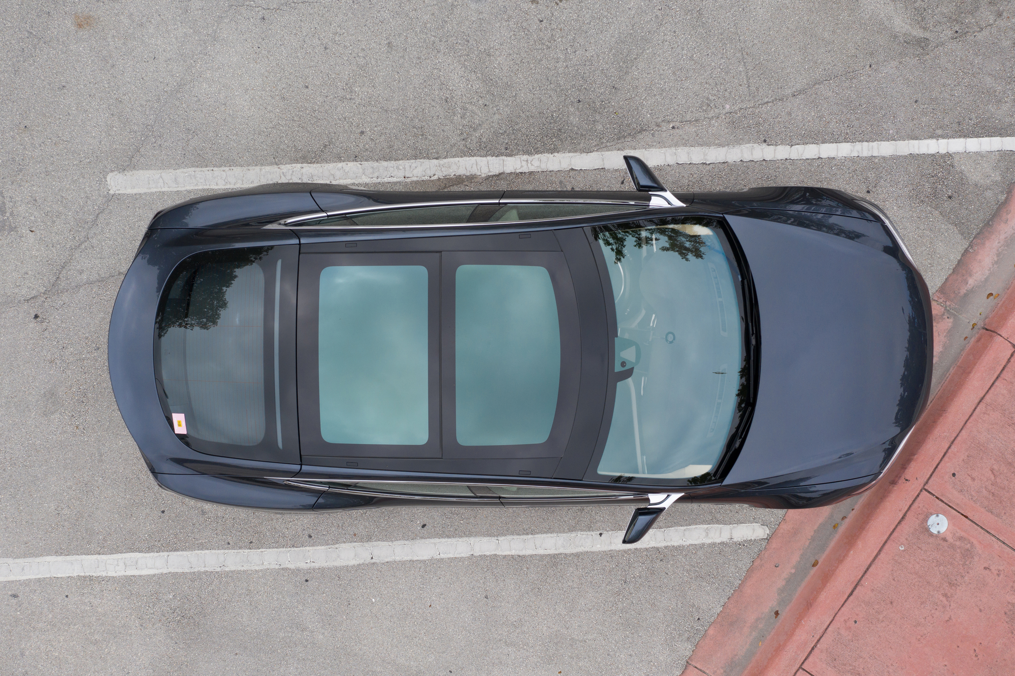 Tesla with big panorama sunroof, aerial view