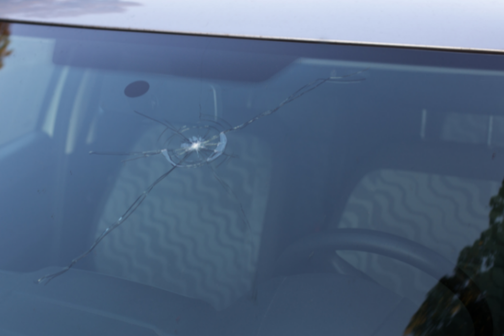 Stone chip and cracks on the middle of a windshield