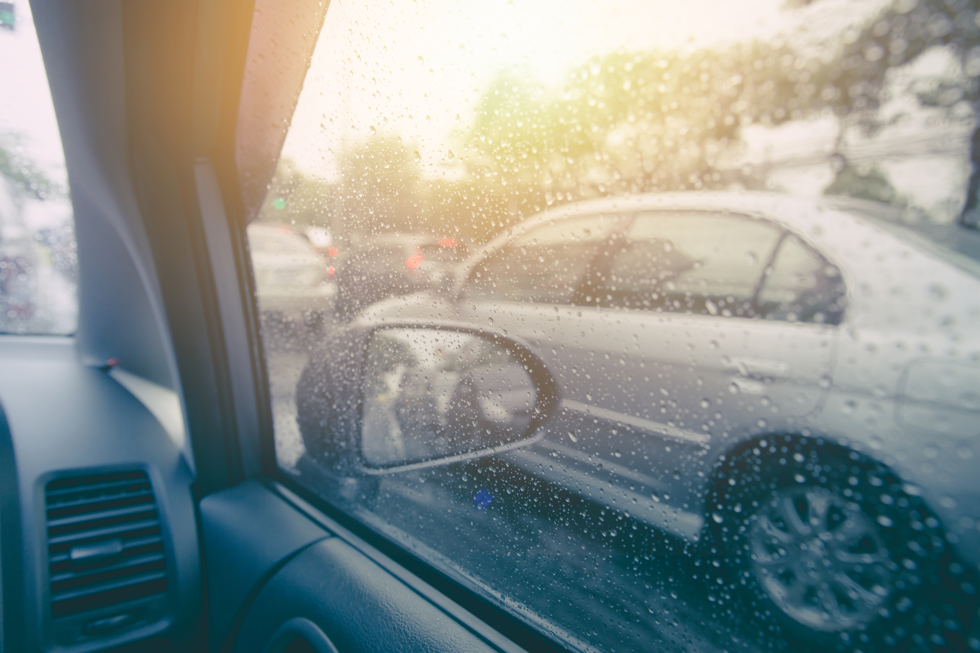 View on rainy weather through car side window