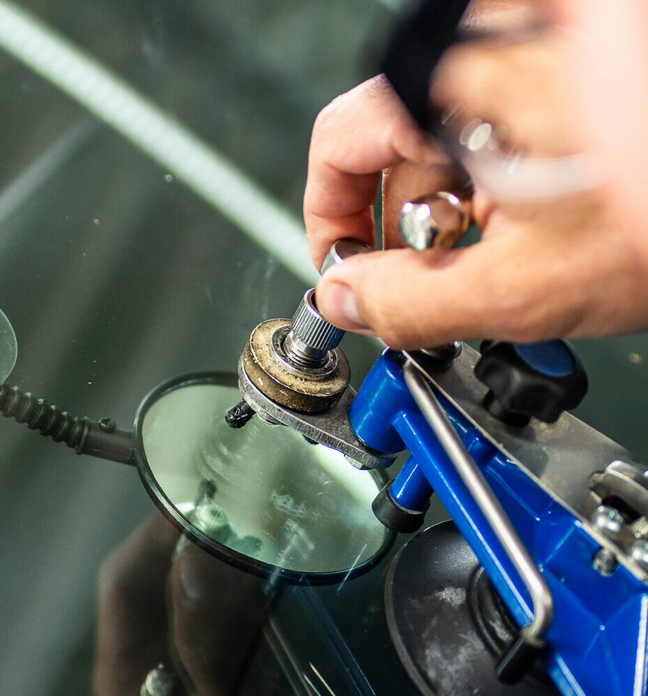 Technician perform windshield repair process