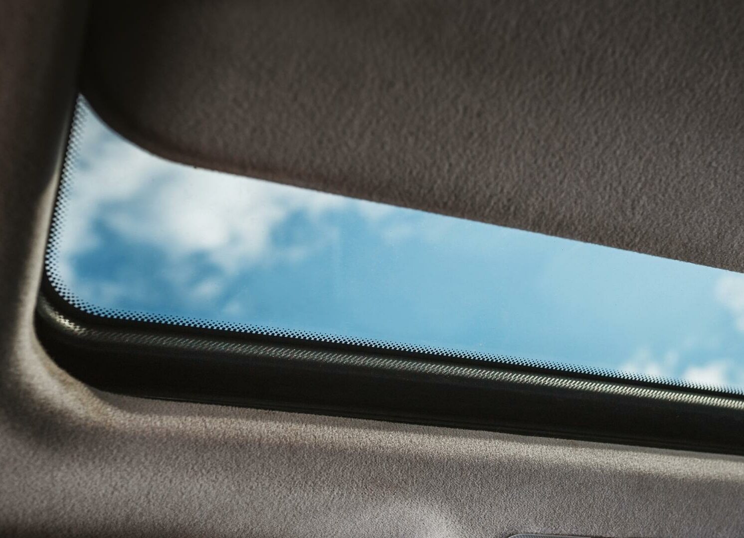 Close up photo of car's glass moonroof with sunshade
