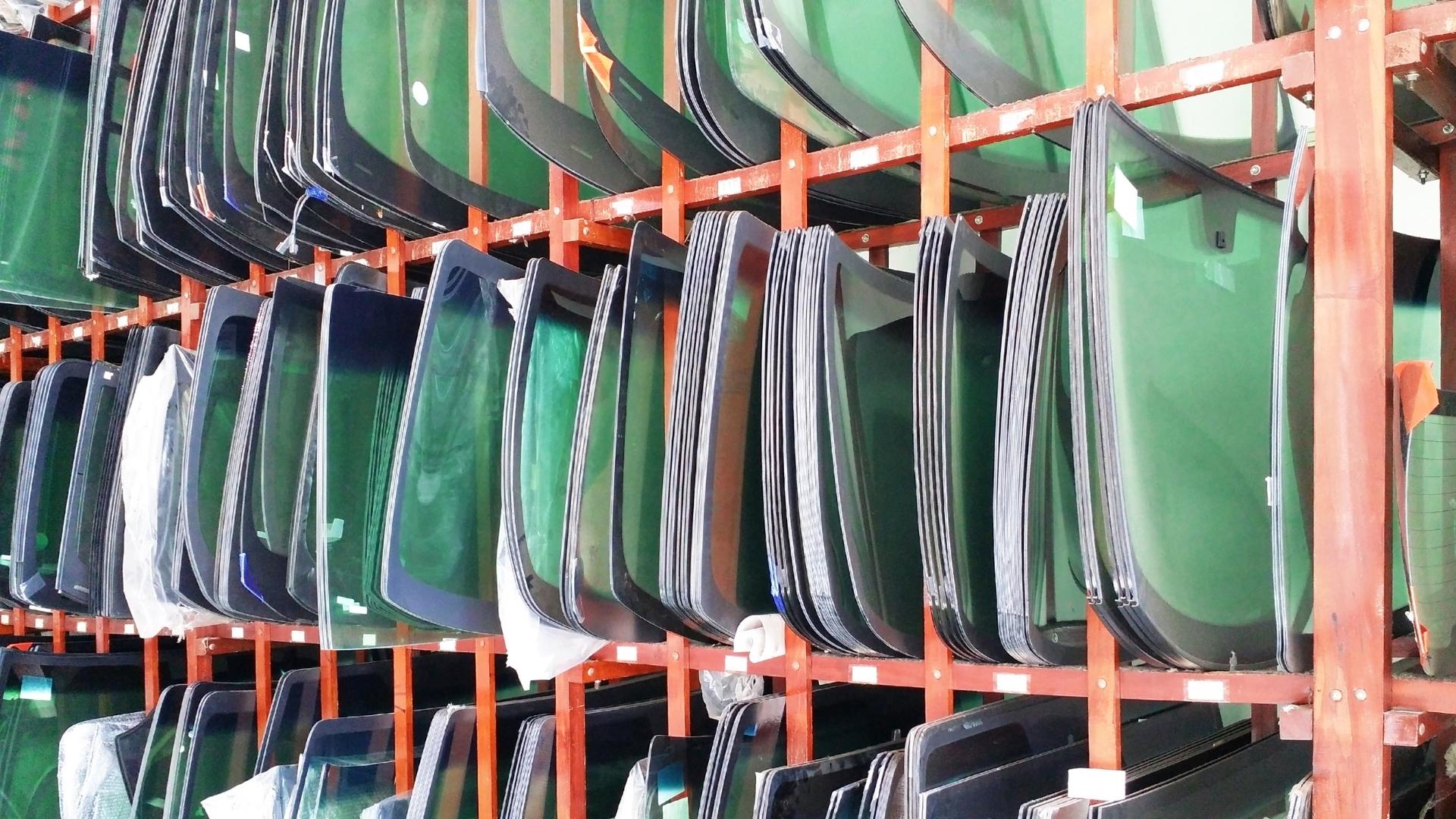 Photo of windshield storage, a lot of windshields on high shelves
