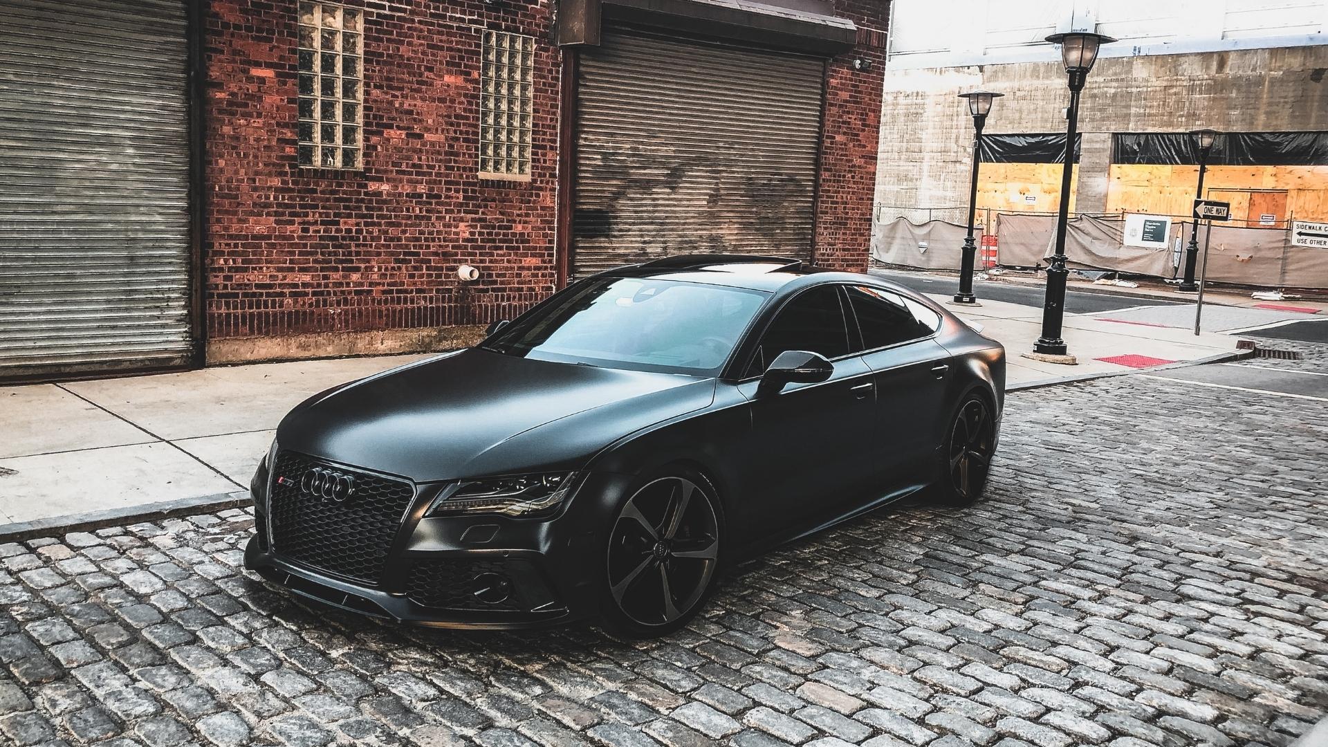 Black wrapped Audi on the brick road, sporty car