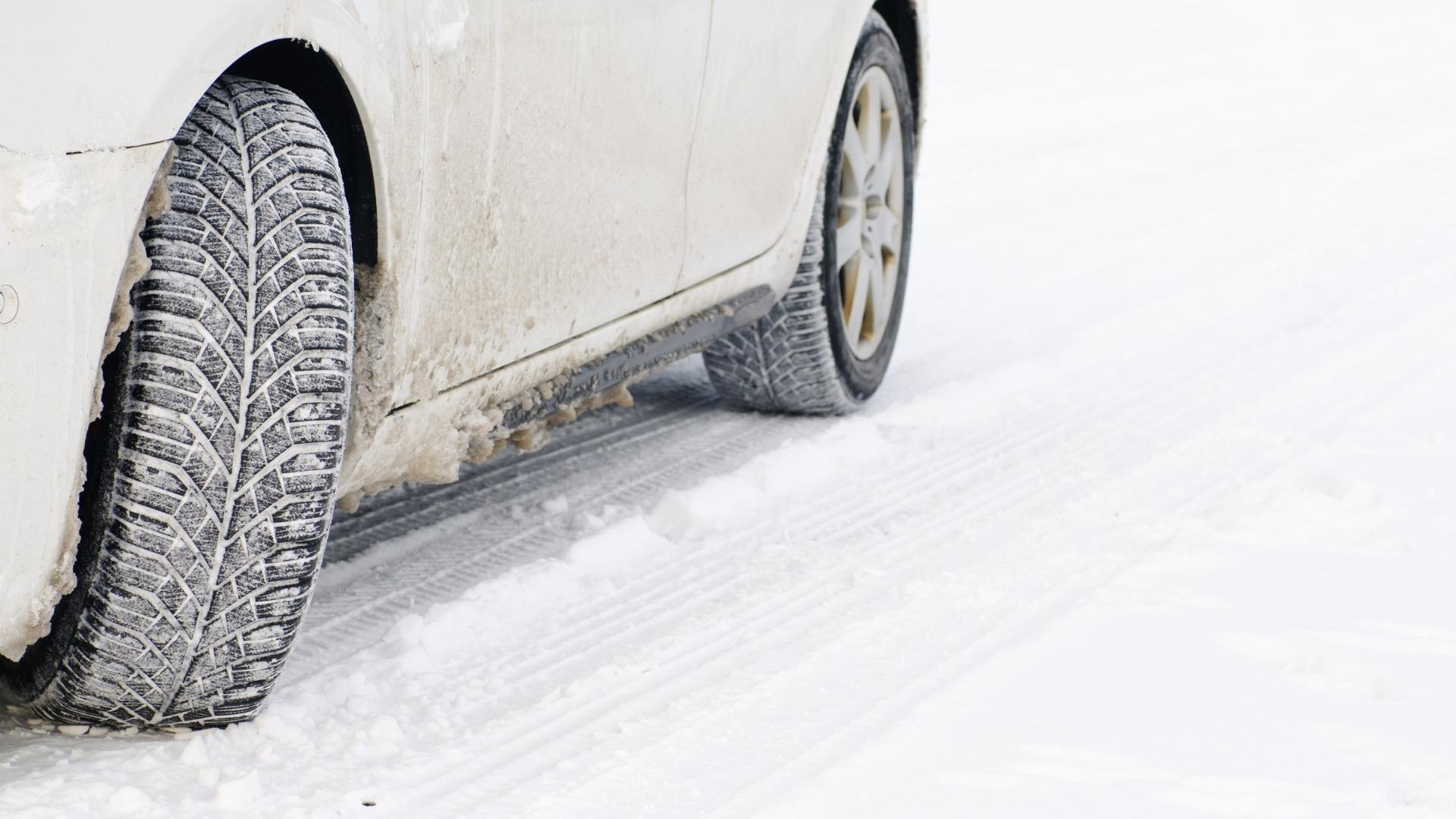 Car in the winter road is covered with road salt and dirt.