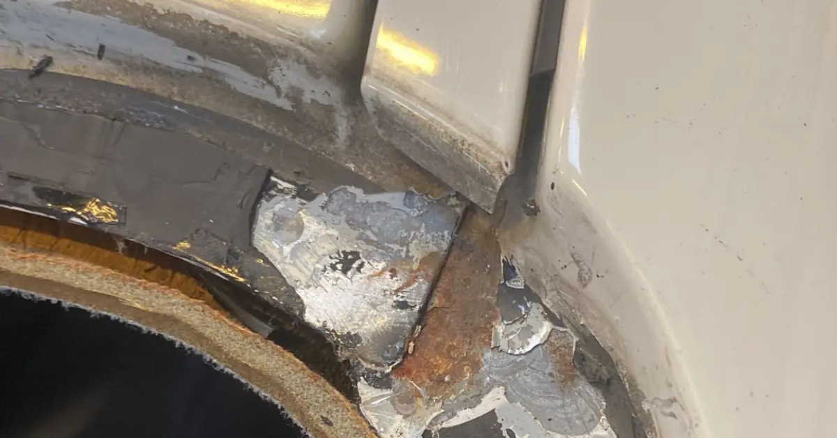 Rust in the windshield frame, particularly at the corner of the rain channel, is a condition where the metal part of the car's body around the windshield begins to corrode.